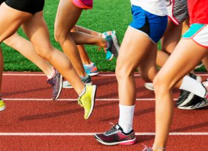 Runners legs on a red track